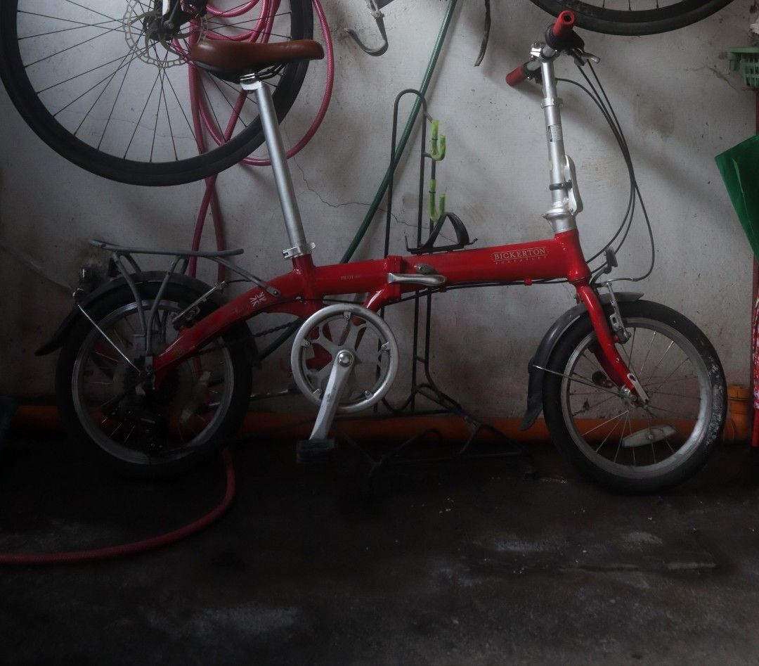 Bickerton Portable Junction 1705 Red Folding Bicycle (Category: Bicycles) located in Taytay. Submitted by iamdion30 (Listing ID 1467224088, Image 2). Description: - Brand: Bickerton - Color: Red - Wheel Size: 16-inch - Gears: Multi-speed setup up to 7 - Extras: Rear rack and fenders included - Comfort: Stylish brown leather saddle - Portability: Compact folding mechanism at frame and stem - Condition: Ready to ride, minor garage dust only - Ideal