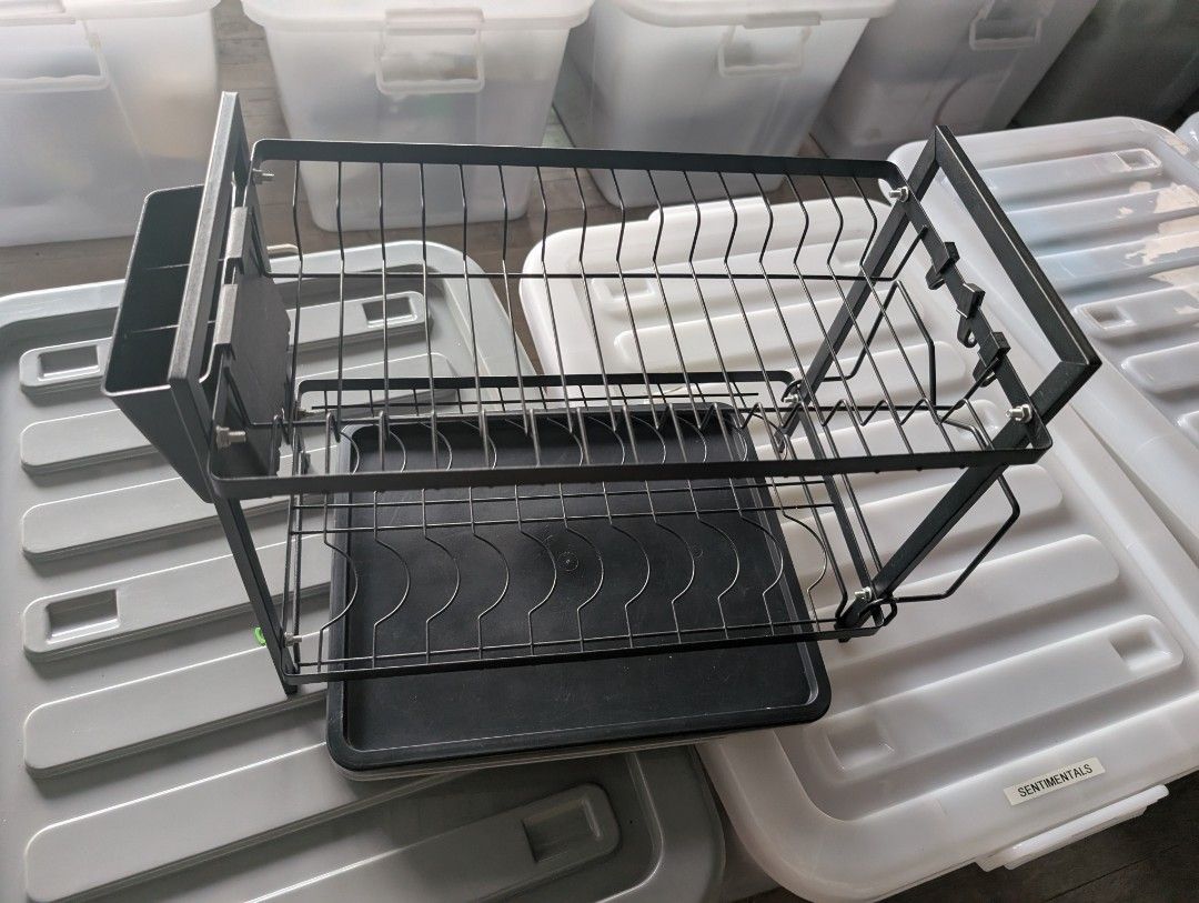 Black 2-Tier Dish Drying Rack with Utensil Holder (Category: Food Organization & Storage) located in Manila. Submitted by coolshark888 (Listing ID 1467326558, Image 2). Description: - Two-tier metal dish drying rack in a sleek black finish - Includes a bottom plastic drainage tray to keep counters dry - Hanging cutlery holder and built-in hooks for extra storage - Sturdy wire frame holds plates securely upright on both levels - Clean and ready fo