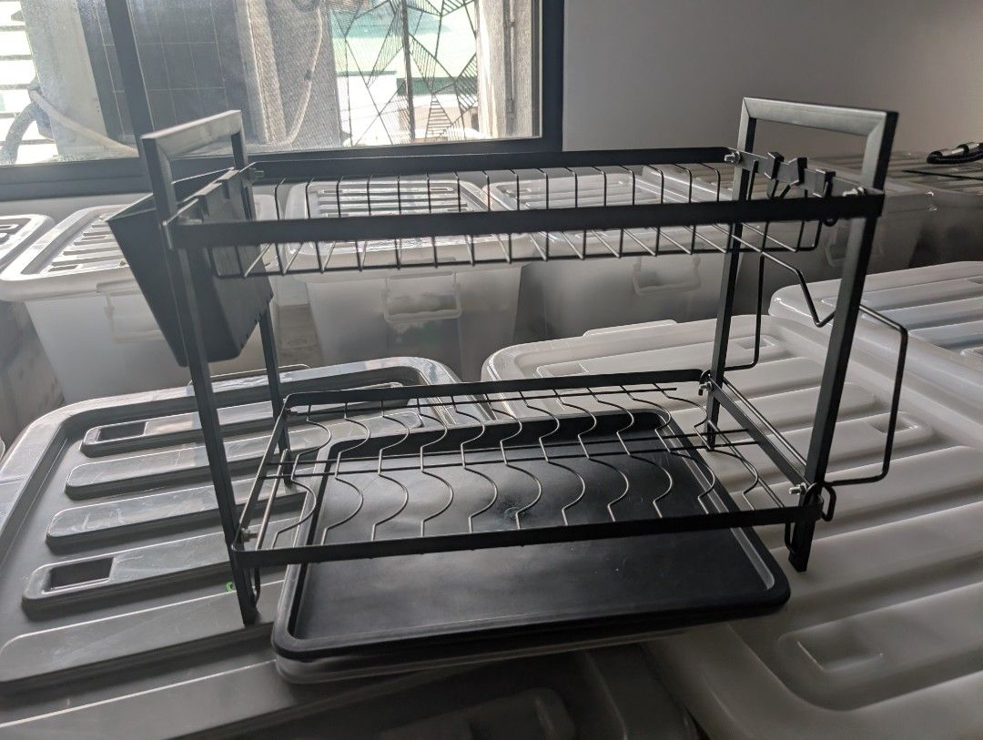 Black 2-Tier Dish Drying Rack with Utensil Holder (Category: Food Organization & Storage) located in Manila. Submitted by coolshark888 (Listing ID 1467326558, Image 1). Description: - Two-tier metal dish drying rack in a sleek black finish - Includes a bottom plastic drainage tray to keep counters dry - Hanging cutlery holder and built-in hooks for extra storage - Sturdy wire frame holds plates securely upright on both levels - Clean and ready fo
