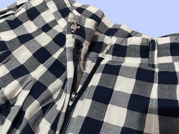 Black and White Gingham Pleated Shorts (Category: Shorts) located in Manila. Submitted by joclutter (Listing ID 1467317502, Image 2). Description: - Pattern: Classic black and white gingham - Fit: High-waisted with front pleats and belt loops - Closure: Secure zip fly with clasp - Interior: Fully lined for comfort - Fabric: Lightweight, ideal for warm weather - Quality: Clean hems and neat stitching throughout.