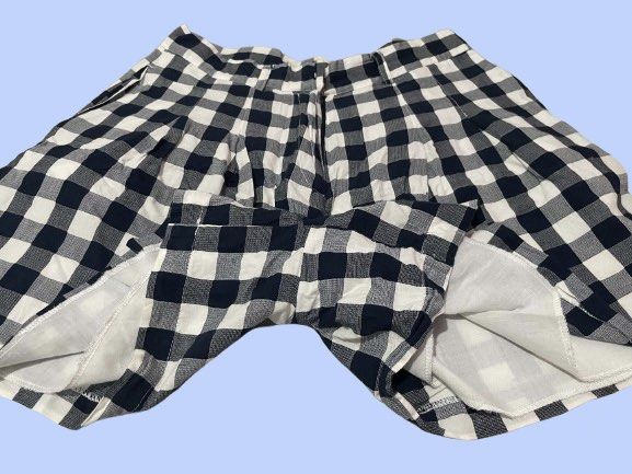 Black and White Gingham Pleated Shorts (Category: Shorts) located in Manila. Submitted by joclutter (Listing ID 1467317502, Image 3). Description: - Pattern: Classic black and white gingham - Fit: High-waisted with front pleats and belt loops - Closure: Secure zip fly with clasp - Interior: Fully lined for comfort - Fabric: Lightweight, ideal for warm weather - Quality: Clean hems and neat stitching throughout.