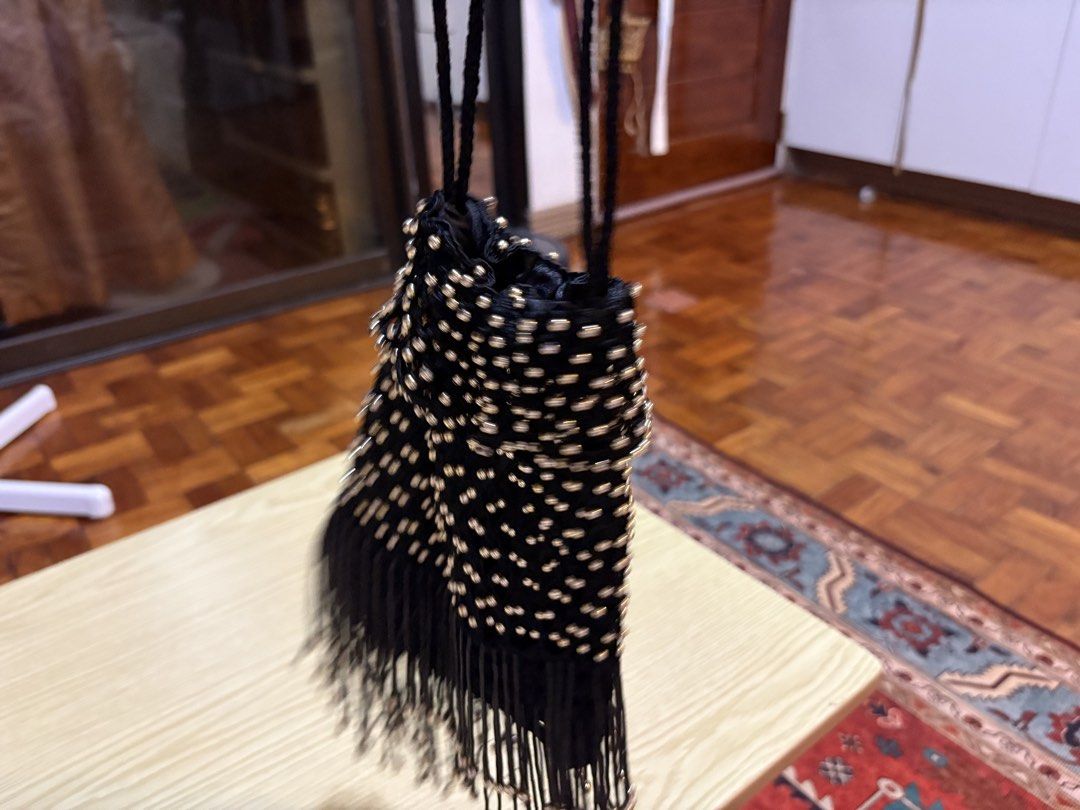 Black Beaded Fringe Evening Bag with Drawstring (Category: Shoulder Bags) located in Quezon City. Submitted by prelovedbybea (Listing ID 1467332886, Image 2). Description: - Color & Material: Black fabric covered in sparkling metallic gold beads - Design: Stylish drawstring closure with a playful long fringe hanging from the bottom - Strap: Comfortable long black braided strap for hands-free wear - Occasion: Ideal accessory for parties, night out