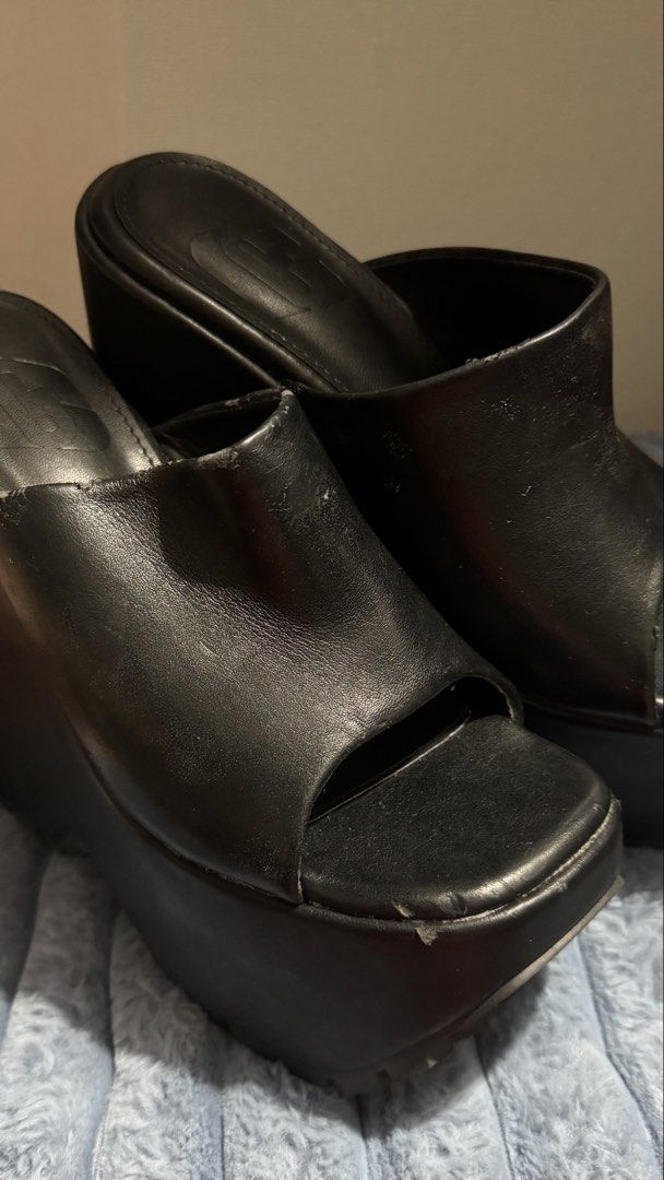 Black chunky platform wedge mules peep toe sandals (Category: Wedges) located in Manila. Submitted by dara_29 (Listing ID 1467188806, Image 1). Description: - Style: vintage bold platform wedge mules - Design: Slip-on with wide top straps, open toes, heavy chunky heels, and thick soles - Branding: Stamped logo on insoles - Condition: Slight wear along upper edges and front bumper.