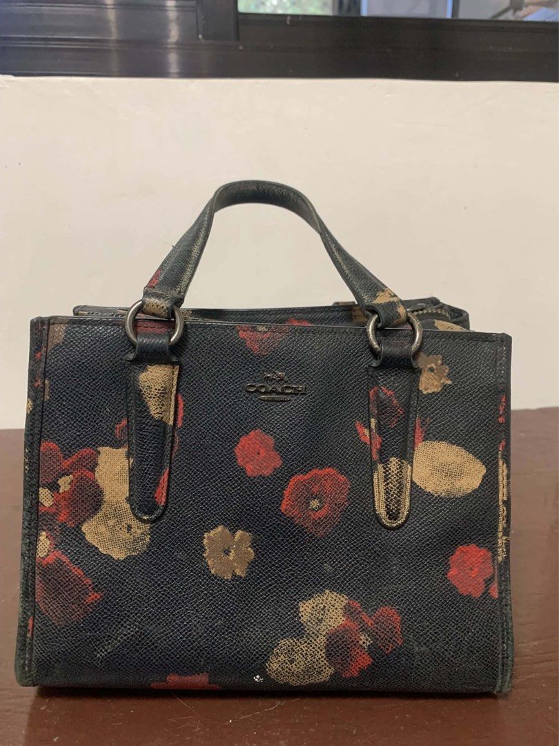 Black COACH Bag with strap (Genuine) (Category: Cross-body Bags) located in Borongan. Submitted by kabes_jane (Listing ID 1467191747, Image 2). Description: - Elegant black structured handbag with a vibrant red and gold floral pattern - Dual top handles secured with stylish metal hardware rings - Spacious double compartment design with secure top zip closure - Crafted from durable textured faux leather - Perfect everyday tote size for work, erran