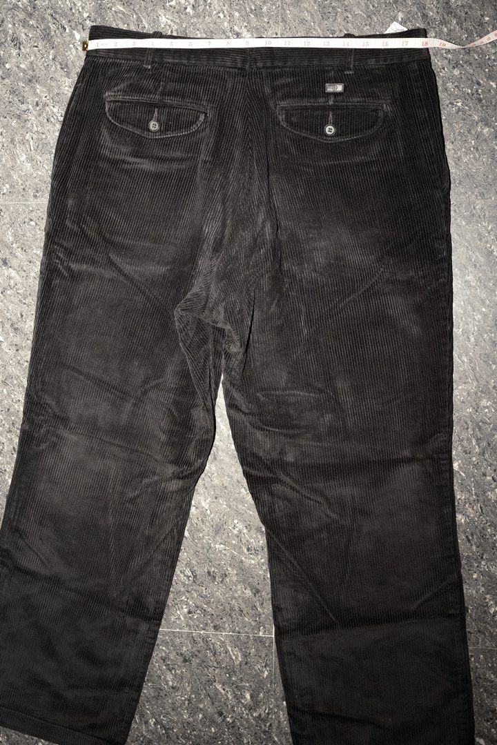 Black Corduroy Trousers with Button Pockets Size 18 (Category: Trousers) located in Guiguinto. Submitted by aries_ji (Listing ID 1467251221, Image 1). Description: - Color: Black - Material: Textured ribbed corduroy - Fit: Straight leg cut, versatile for everyday wear - Waist: 18 to 19 inches flat across - Details: Two back pockets with button flaps and a metal branded tag above the right pocket.