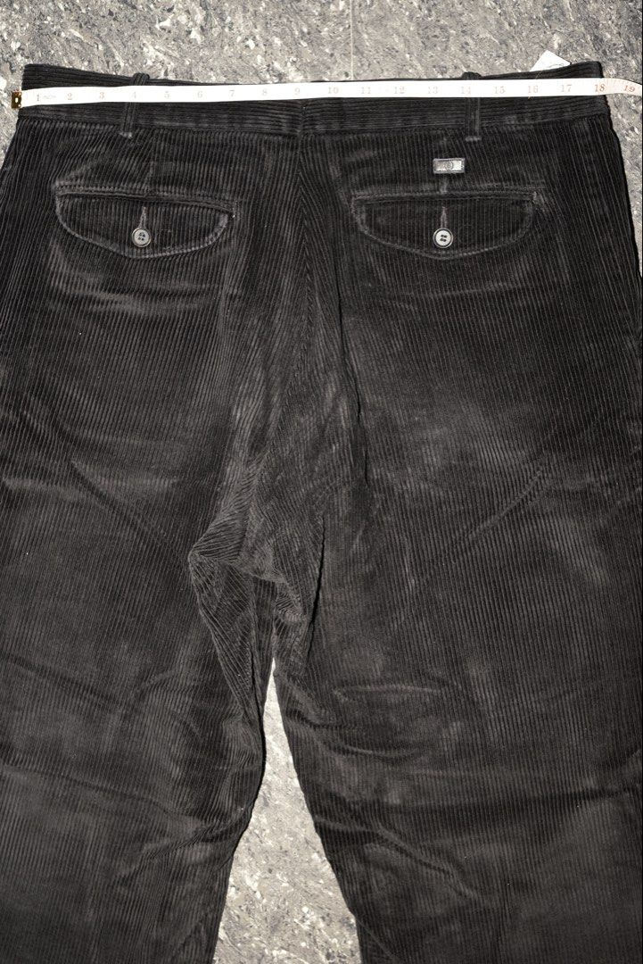 Black Corduroy Trousers with Button Pockets Size 18 (Category: Trousers) located in Guiguinto. Submitted by aries_ji (Listing ID 1467251221, Image 3). Description: - Color: Black - Material: Textured ribbed corduroy - Fit: Straight leg cut, versatile for everyday wear - Waist: 18 to 19 inches flat across - Details: Two back pockets with button flaps and a metal branded tag above the right pocket.