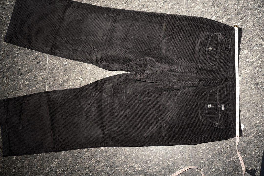 Black Corduroy Trousers with Button Pockets Size 18 (Category: Trousers) located in Guiguinto. Submitted by aries_ji (Listing ID 1467251221, Image 2). Description: - Color: Black - Material: Textured ribbed corduroy - Fit: Straight leg cut, versatile for everyday wear - Waist: 18 to 19 inches flat across - Details: Two back pockets with button flaps and a metal branded tag above the right pocket.