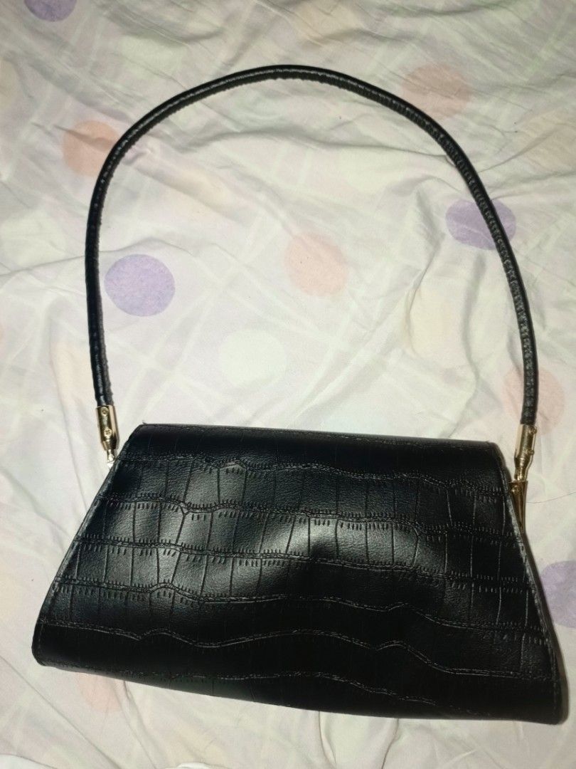 Black Croc Embossed Shoulder Bag Chic Purse (Category: Shoulder Bags) located in Manila. Submitted by erjasp41267218 (Listing ID 1467342061, Image 2). Description: - Color: Black - Material/Texture: All-over crocodile pattern - Design: Structured trapezoid shape with front flap closure - Hardware: Gold-tone rings attached to a thin shoulder strap - Versatility: Ideal for casual daily wear or evening events - Style: Minimalist and easy to match bo