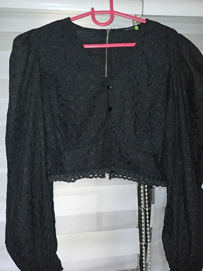 Black Eyelet Crop Puffsleeves (Category: Longsleeves) located in Makati City. Submitted by closet.declutterph (Listing ID 1467213462, Image 1). Description: - Brand/Style: Tokyo Urban black crop blouse - Size: S - Design: Long puffy sleeves with elastic cuffs, textured eyelet fabric with circular pattern - Details: Front zipper accent, decorative front buttons, and a scalloped hem - Fit: Cropped length, perfect for high-waisted denim or skirts - 