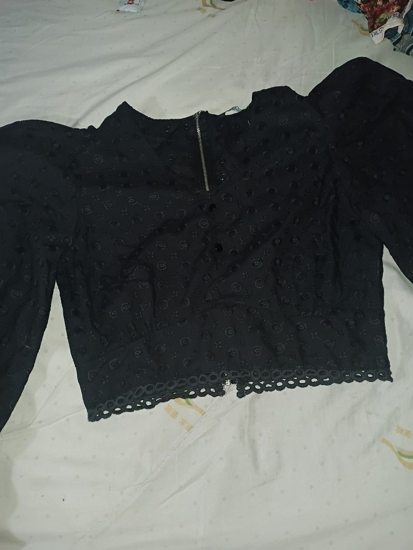 Black Eyelet Crop Puffsleeves (Category: Longsleeves) located in Makati City. Submitted by closet.declutterph (Listing ID 1467213462, Image 3). Description: - Brand/Style: Tokyo Urban black crop blouse - Size: S - Design: Long puffy sleeves with elastic cuffs, textured eyelet fabric with circular pattern - Details: Front zipper accent, decorative front buttons, and a scalloped hem - Fit: Cropped length, perfect for high-waisted denim or skirts - 