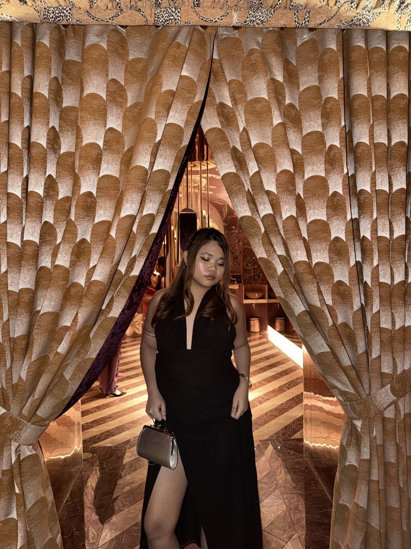 Black Halter Neck Slit Maxi Dress (Category: Dresses) located in Manila. Submitted by renkacoleni (Listing ID 1467222079, Image 3). Description: - Style: Black maxi dress with deep V-neck and halter strap - Details: Draped front waist and high thigh slit on the right leg - Material: Sleek satin-like fabric - Condition: Worn once, freshly dry-cleaned, and ready to wear - Perfect for: Evening outs, parties, and formal events.