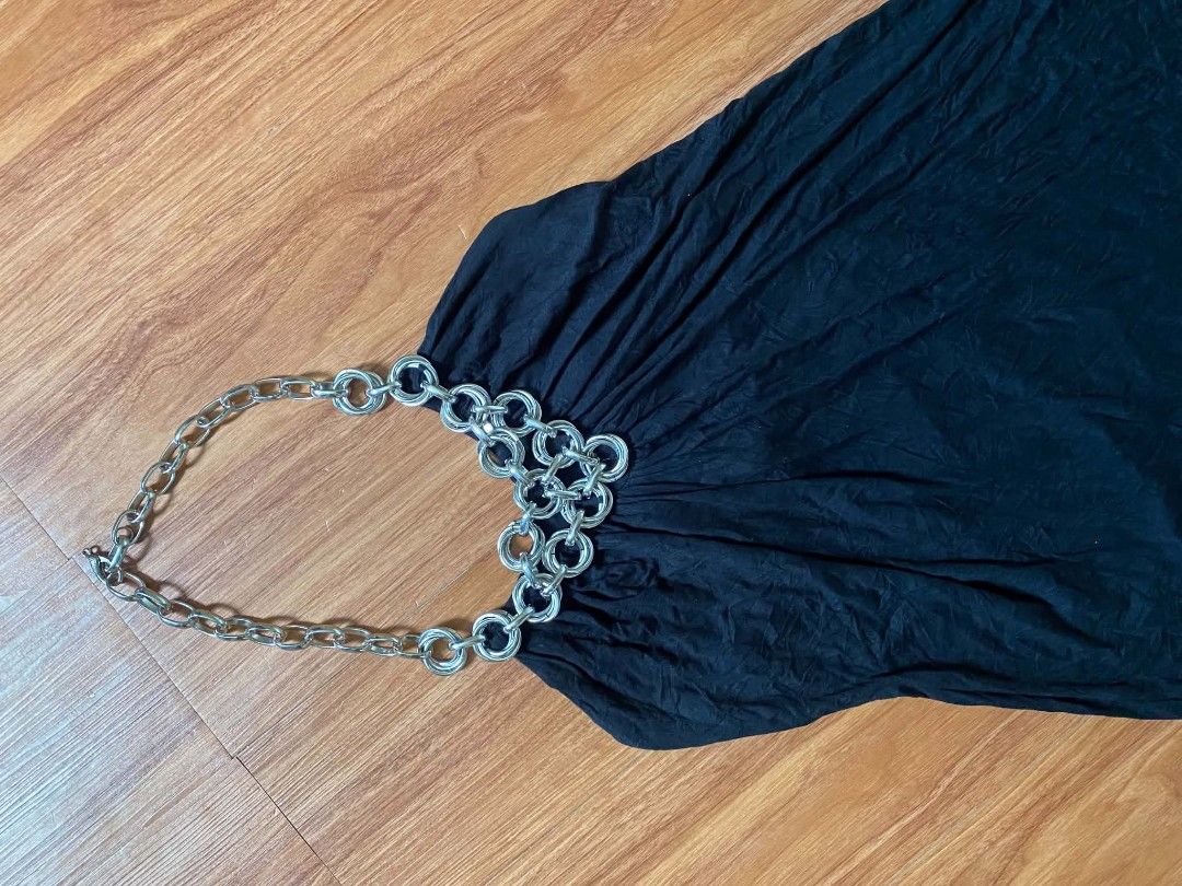 Black Halter Top with Silver Chain Neck Detail (Category: Sleeveless) located in Malasiqui. Submitted by finnley26 (Listing ID 1467246722, Image 2). Description: - Color: Black - Style: Sleeveless halter top with built-in chunky silver chain and ring hardware - Fabric: Soft textured material with a gathered, draped front - Fit: Flared hemline, easy to style - Occasion: Perfect for parties and nights out (pairs great with jeans or a skirt) - Condi