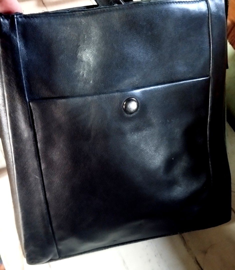Black leather shoulder bag with front pocket (Category: Sling Bags) located in Manila. Submitted by lene48 (Listing ID 1467211600, Image 1). Description: - Color & Material: Black leather everyday shoulder bag - Compartments: Structured main compartment with interior space, plus a front slip pocket with button closure - Strap: Adjustable strap with metal buckle and hardware details - Condition: Good pre-loved condition with slight corner scuffing