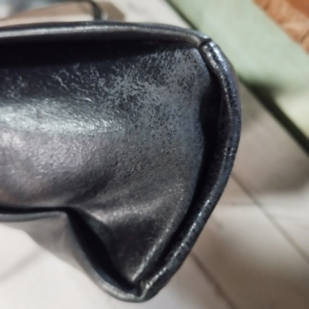 Black leather shoulder bag with front pocket (Category: Sling Bags) located in Manila. Submitted by lene48 (Listing ID 1467211600, Image 3). Description: - Color & Material: Black leather everyday shoulder bag - Compartments: Structured main compartment with interior space, plus a front slip pocket with button closure - Strap: Adjustable strap with metal buckle and hardware details - Condition: Good pre-loved condition with slight corner scuffing