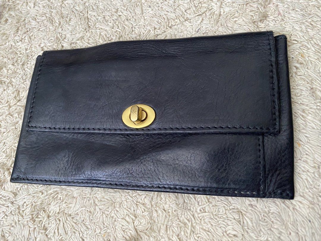 Black Leather Twist Lock Wallet Pouch (Category: Wallets & Card holders) located in Baguio. Submitted by SweetRepeat (Listing ID 1467193097, Image 1). Description: - Color/Material: Black leather with raw suede interior lining - Closure: Elegant gold twist lock on the front flap - Fit: Slim profile that easily fits a standard smartphone and daily essentials - Condition: Minor wear on the leather surface from previous handling - Style: Compact, ve