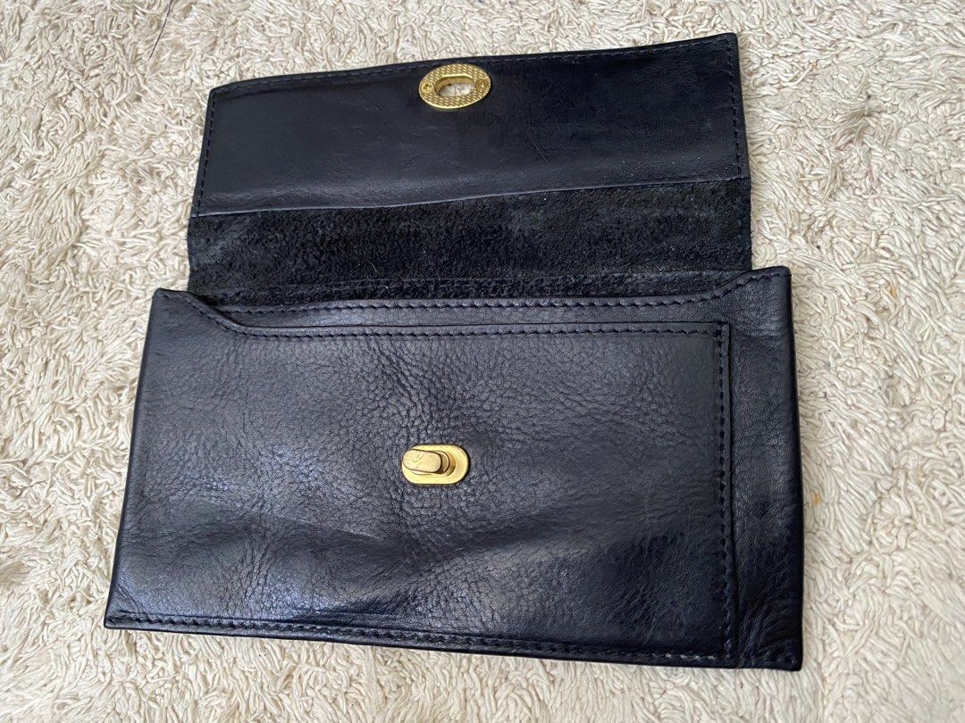 Black Leather Twist Lock Wallet Pouch (Category: Wallets & Card holders) located in Baguio. Submitted by SweetRepeat (Listing ID 1467193097, Image 3). Description: - Color/Material: Black leather with raw suede interior lining - Closure: Elegant gold twist lock on the front flap - Fit: Slim profile that easily fits a standard smartphone and daily essentials - Condition: Minor wear on the leather surface from previous handling - Style: Compact, ve