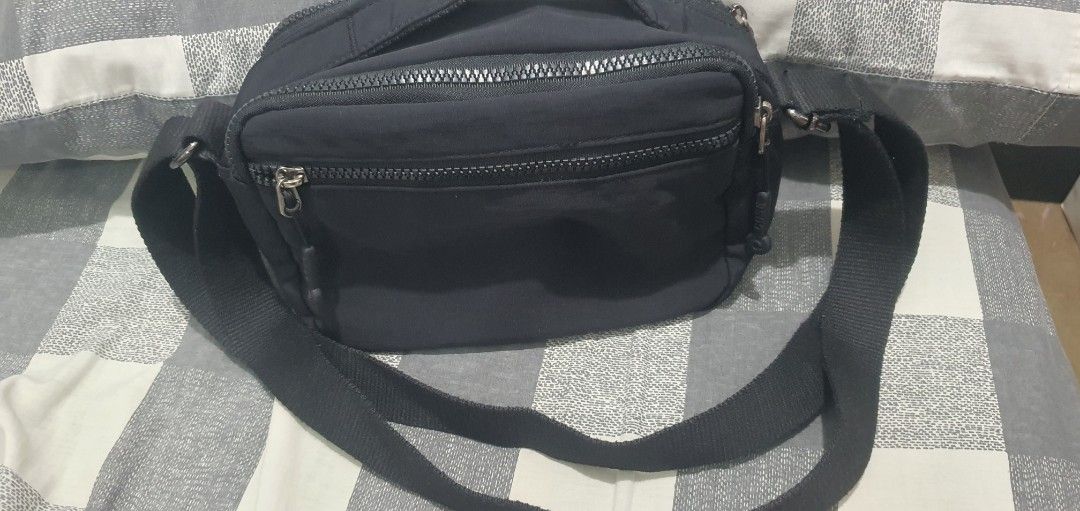 Black Nylon Multi-Zip Crossbody Bag (Category: Cross-body Bags) located in Paranaque City. Submitted by personal_preloved40 (Listing ID 1467260556, Image 2). Description: - Material: Durable black nylon - Strap: Adjustable for easy carrying - Storage: Multiple zippered compartments with a secure inner zip pocket - Interior: Solid black lining, very clean - Hardware: Sturdy, smooth-working zippers Has minimal issue handle need to be stitched see 8