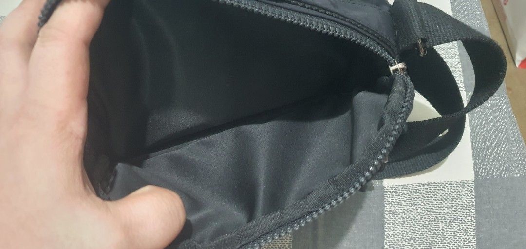 Black Nylon Multi-Zip Crossbody Bag (Category: Cross-body Bags) located in Paranaque City. Submitted by personal_preloved40 (Listing ID 1467260556, Image 3). Description: - Material: Durable black nylon - Strap: Adjustable for easy carrying - Storage: Multiple zippered compartments with a secure inner zip pocket - Interior: Solid black lining, very clean - Hardware: Sturdy, smooth-working zippers Has minimal issue handle need to be stitched see 8