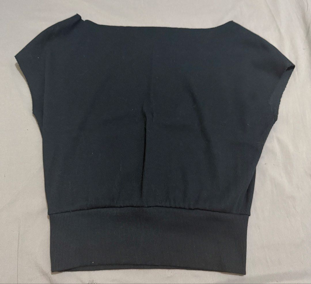 Black One-Shoulder Ribbed Knit Top (Category: Sleeveless) located in Las Pinas. Submitted by luvvjeon (Listing ID 1467318179, Image 2). Description: - Color: Black - Style: One-shoulder knit top with short cap sleeves - Fit: Stretchy, comfortable fabric with a wide fitted hem to keep it tucked in - Versatility: Perfect for pairing with high-waisted pants or skirts.