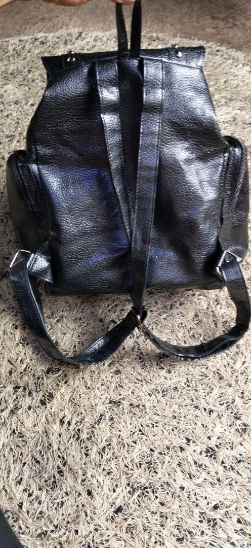 Black Punk Studded Cross Backpack unisex smooth leather (Category: Backpacks) located in Paranaque City. Submitted by michael-08 (Listing ID 1467249364, Image 2). Description: - Style: Edgy gothic design with silver studs and a bold cross emblem - Material: Durable black faux leather - Closure: Flap with drawstring underneath - Pockets: Convenient zipped front pocket and side zipper pockets - Comfort: Adjustable shoulder straps for everyday carry