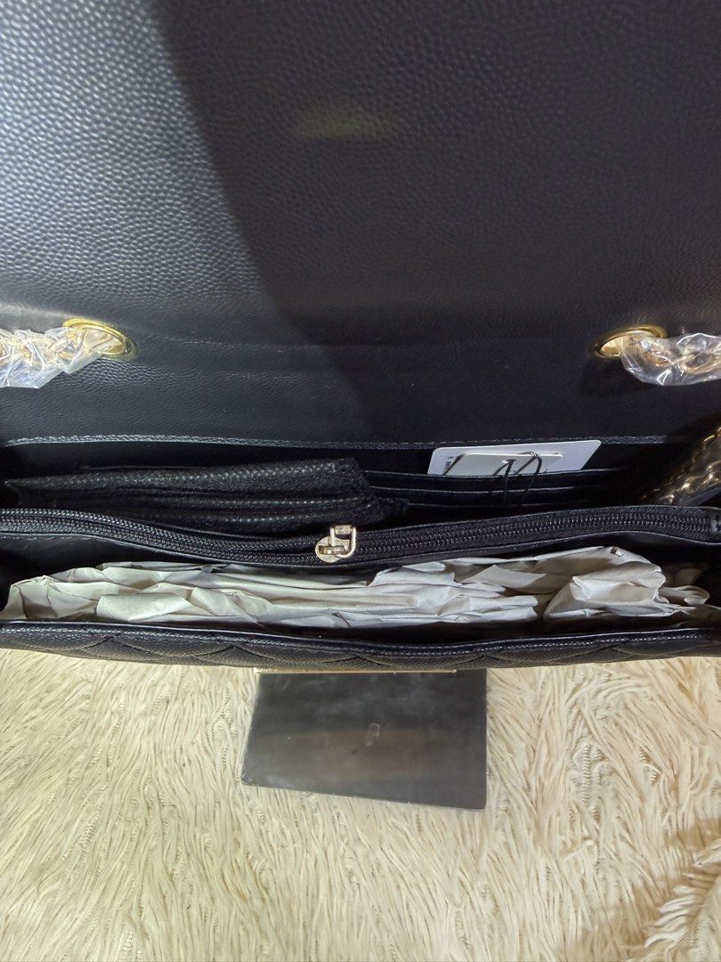 Black Quilted Chain Shoulder Bag (Category: Shoulder Bags) located in Caloocan City. Submitted by hirahira.co (Listing ID 1467285493, Image 3). Description: - Style: Black textured faux leather shoulder bag with diamond quilted pattern - Hardware: Elegant gold-tone chain strap and metallic bar accent - Closure: Front flap closure - Interior: Includes a zipper compartment, slip pockets, and card slots - Condition: Brand new with stuffing paper ins