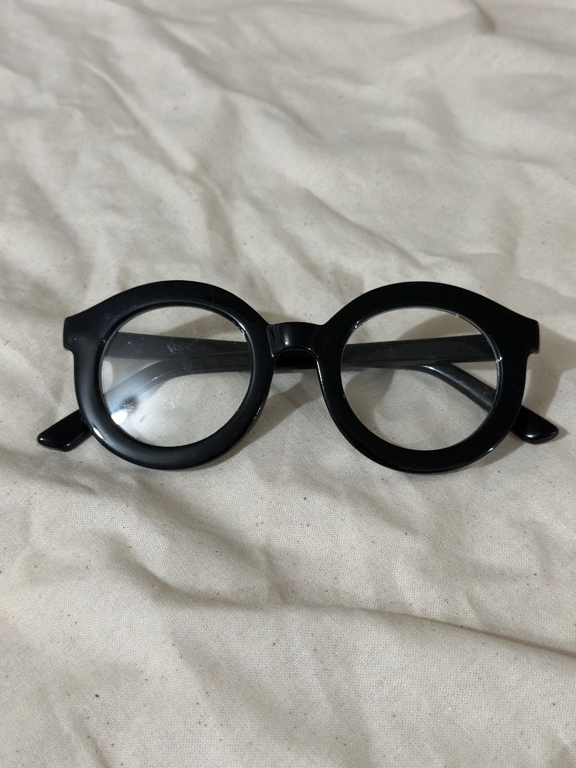 Black Round Frame Glasses Chunky Retro Eyewear (Category: Sunglasses & Eyewear) located in Mandaluyong City. Submitted by lovedbyjaaaam (Listing ID 1467279684, Image 1). Description: - Chunky black frames with a trendy circular round shape - Fitted with clear, non-prescription lenses - Stylish glossy finish on durable plastic material - Lightweight and comfortable for all-day wear - Perfect statement piece to elevate any outfit.