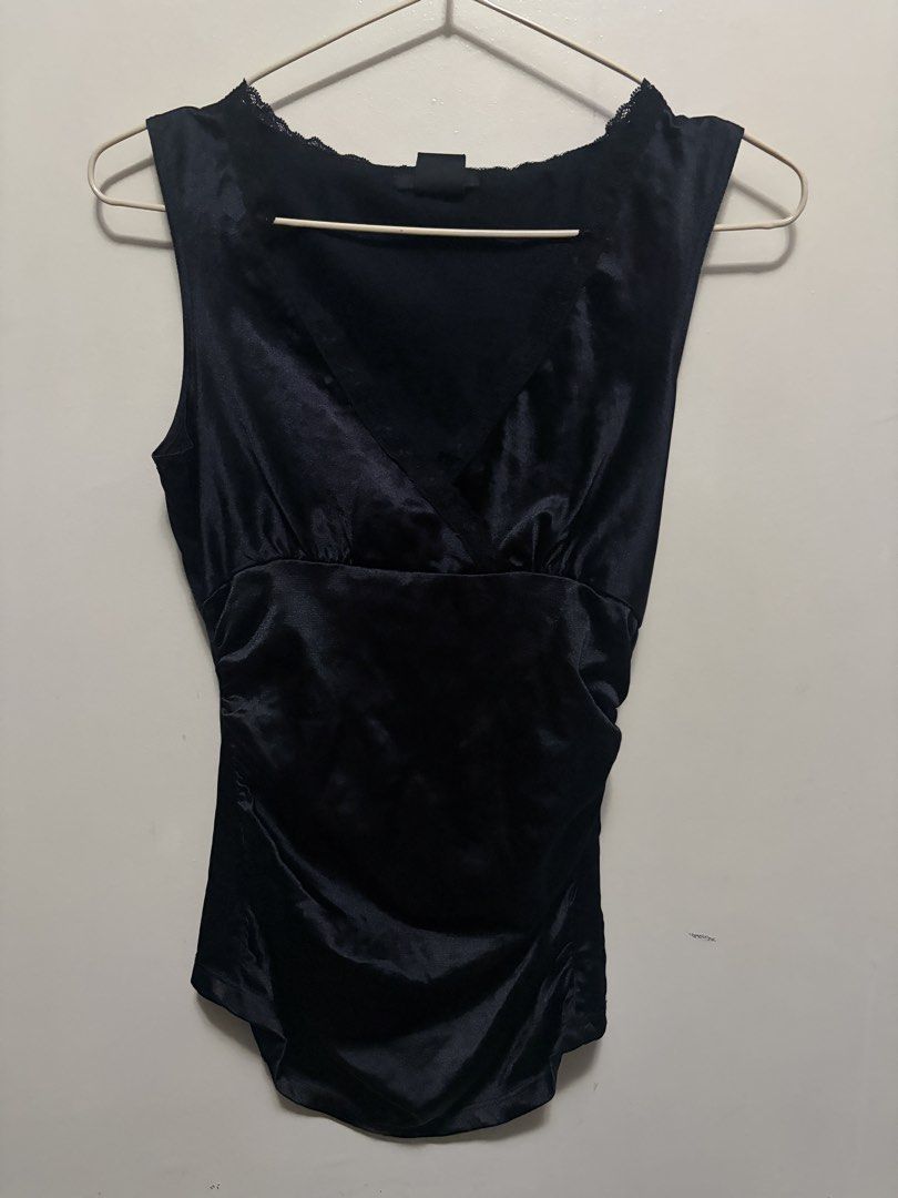 Black satin cami top with lace trim (Category: Sleeveless) located in Quezon City. Submitted by j.steffy (Listing ID 1467323097, Image 1). Description: - Material: Smooth satin with a nice sheen - Design: V-neck with delicate black lace trim - Fit: Side ruching for a fitted, flattering silhouette - Style: Sleeveless, great for layering under cardigans or jackets - Condition: Tag intact at the back collar.