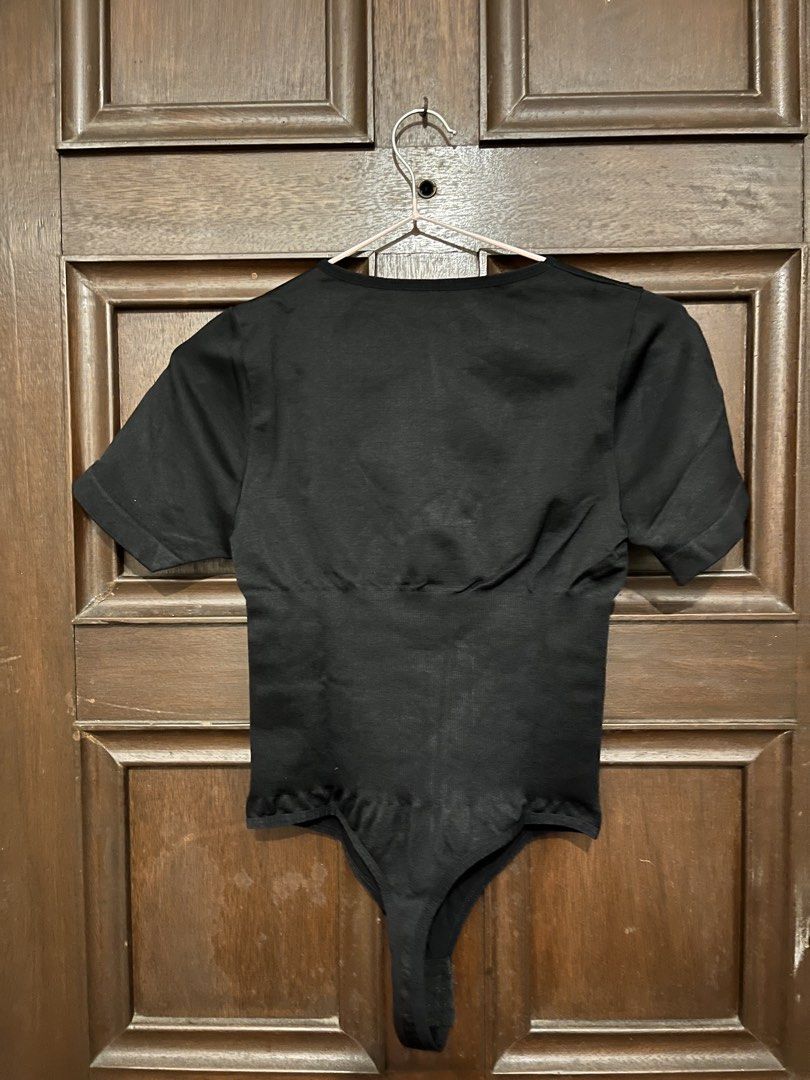 Black Shapewear Bodysuit (Category: Blouses) located in Makati City. Submitted by yoursecondbest (Listing ID 1467255063, Image 2). Description: - Color: Black - Style: Short sleeve bodysuit with built-in waist and midsection shaping panels - Fabric: Stretchy, seamless knit construction - Closure: Bottom snap closure.