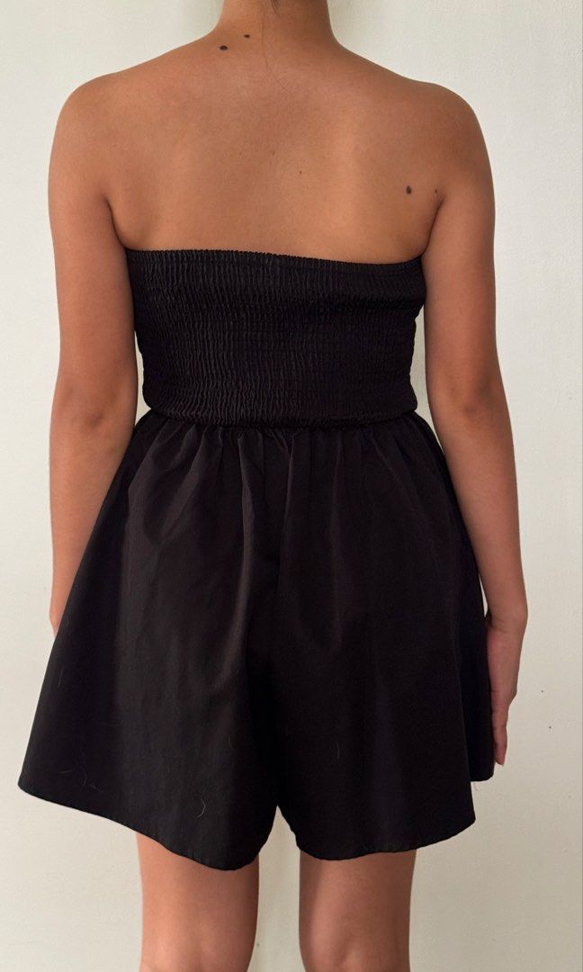 Black Strapless Smocked Romper Playsuit (Category: Rompers) located in Cabanatuan. Submitted by gentle_declutteringg (Listing ID 1467230265, Image 2). Description: MODEL IS MEDIUM WEARING SMALL - Style: Black strapless romper with flared shorts - Fit: Secure smocked stretchy bodice that hugs the chest comfortably - Fabric: Lightweight, cool, and perfect for warm weather - Vibe: Casual, effortless, and easy to throw on - Condition: Brand new / Exc