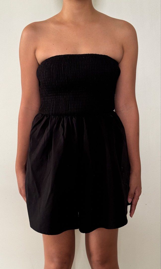 Black Strapless Smocked Romper Playsuit (Category: Rompers) located in Cabanatuan. Submitted by gentle_declutteringg (Listing ID 1467230265, Image 1). Description: MODEL IS MEDIUM WEARING SMALL - Style: Black strapless romper with flared shorts - Fit: Secure smocked stretchy bodice that hugs the chest comfortably - Fabric: Lightweight, cool, and perfect for warm weather - Vibe: Casual, effortless, and easy to throw on - Condition: Brand new / Exc