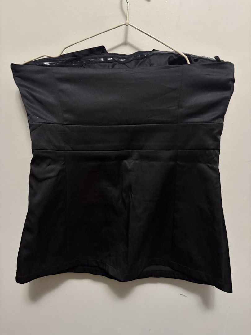 Black strapless tube top with wrap crossover bodice (Category: Sleeveless) located in Quezon City. Submitted by j.steffy (Listing ID 1467323539, Image 3). Description: - Color: Black - Material: Satin-like fabric with a clean hem finish - Design: Strapless tube top with a chic crossover wrap neckline and straight-cut back - Fit & Support: Structured bodice with built-in molded cups and anti-slip grip tape along the top inner edge - Closure: Easy 