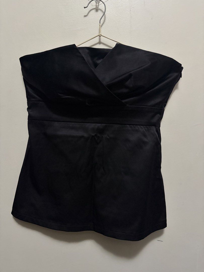Black strapless tube top with wrap crossover bodice (Category: Sleeveless) located in Quezon City. Submitted by j.steffy (Listing ID 1467323539, Image 1). Description: - Color: Black - Material: Satin-like fabric with a clean hem finish - Design: Strapless tube top with a chic crossover wrap neckline and straight-cut back - Fit & Support: Structured bodice with built-in molded cups and anti-slip grip tape along the top inner edge - Closure: Easy 