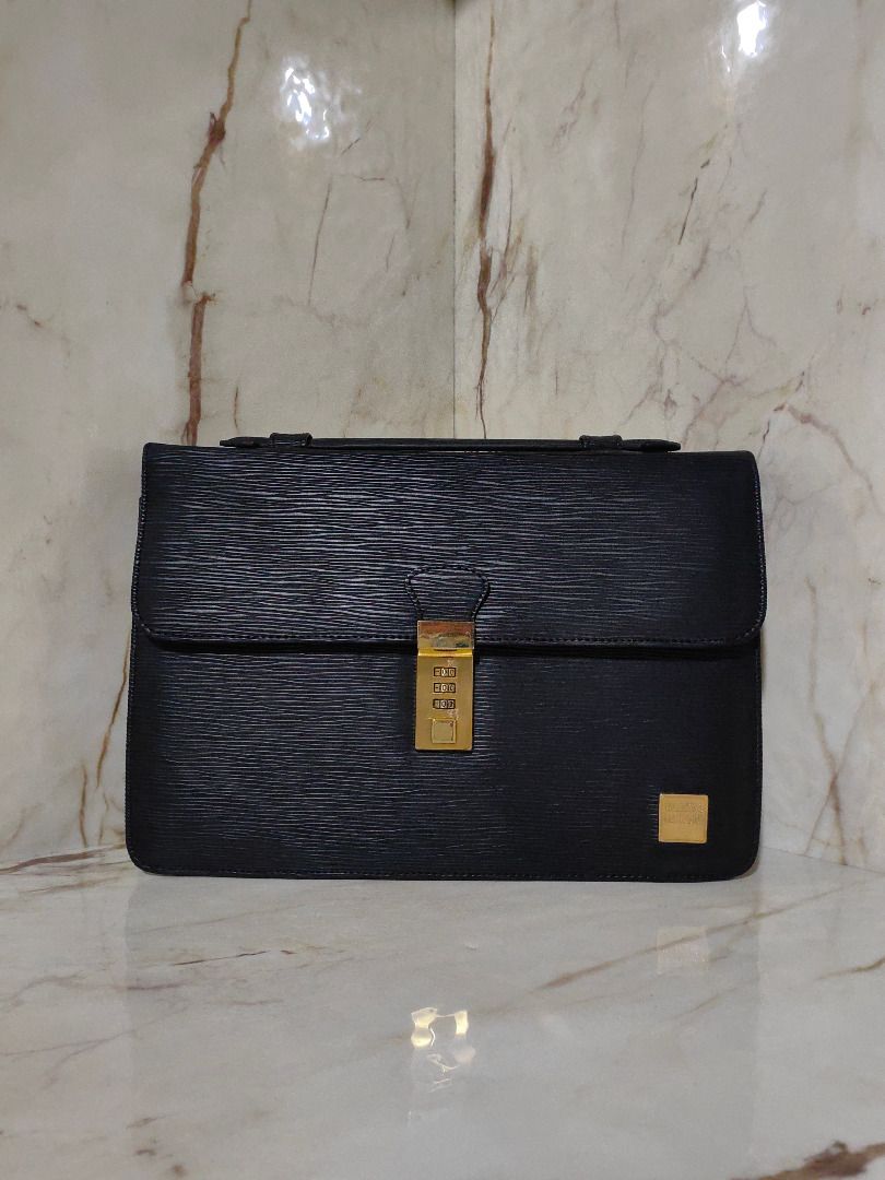 Black Textured Leather Briefcase with Combination Lock (Category: Belt bags, Clutches and Pouches) located in Tarlac. Submitted by jeremiah.curator.2026 (Listing ID 1467342683, Image 1). Description: - Material: Premium black textured leather with luxury gold-tone hardware - Security: Front flap with a secure gold-tone combination lock - Storage: Expandable side gussets for extra capacity and a quick-access back slip pocket - Design: Structured r