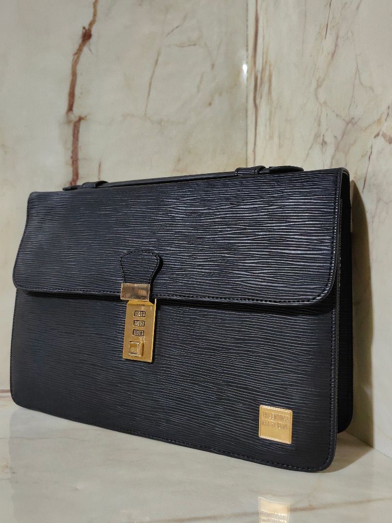 Black Textured Leather Briefcase with Combination Lock (Category: Belt bags, Clutches and Pouches) located in Tarlac. Submitted by jeremiah.curator.2026 (Listing ID 1467342683, Image 2). Description: - Material: Premium black textured leather with luxury gold-tone hardware - Security: Front flap with a secure gold-tone combination lock - Storage: Expandable side gussets for extra capacity and a quick-access back slip pocket - Design: Structured r