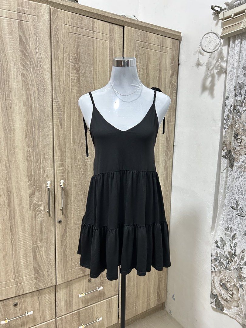 Black Tiered Spaghetti Strap Dress (Category: Dresses) located in Cavite. Submitted by cl09-39734 (Listing ID 1467224332, Image 2). Description: - Color: Classic Black - Style: V-neck tiered dress with adjustable tie shoulders - Fabric: Lightweight and breathable - Versatile: Easy to style for casual days or night outs - Condition: Brand new / Excellent quality.