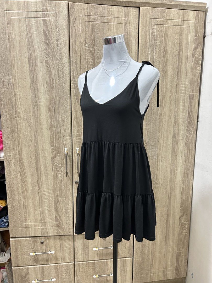 Black Tiered Spaghetti Strap Dress (Category: Dresses) located in Cavite. Submitted by cl09-39734 (Listing ID 1467224332, Image 1). Description: - Color: Classic Black - Style: V-neck tiered dress with adjustable tie shoulders - Fabric: Lightweight and breathable - Versatile: Easy to style for casual days or night outs - Condition: Brand new / Excellent quality.