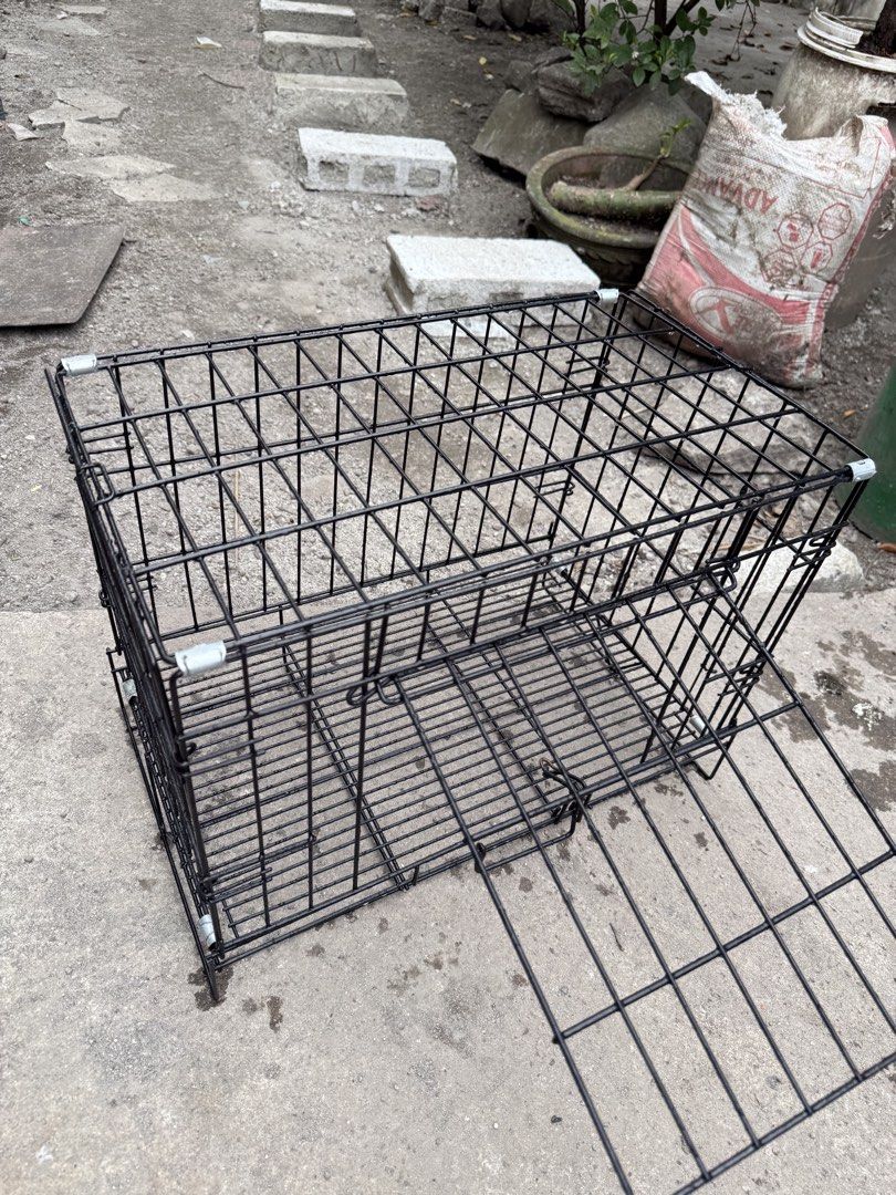 Black Wire Pet Cage with Front Door (Category: Homes & Other Pet Accessories) located in Manila. Submitted by tracysophi08245 (Listing ID 1467257163, Image 3). Description: - Sturdy black wire metal construction - Drop-down front door with a secure latch closure for easy access - Includes top and side wire panels for great ventilation - Ideal size for small dogs or cats - Clean condition and ready to use.
