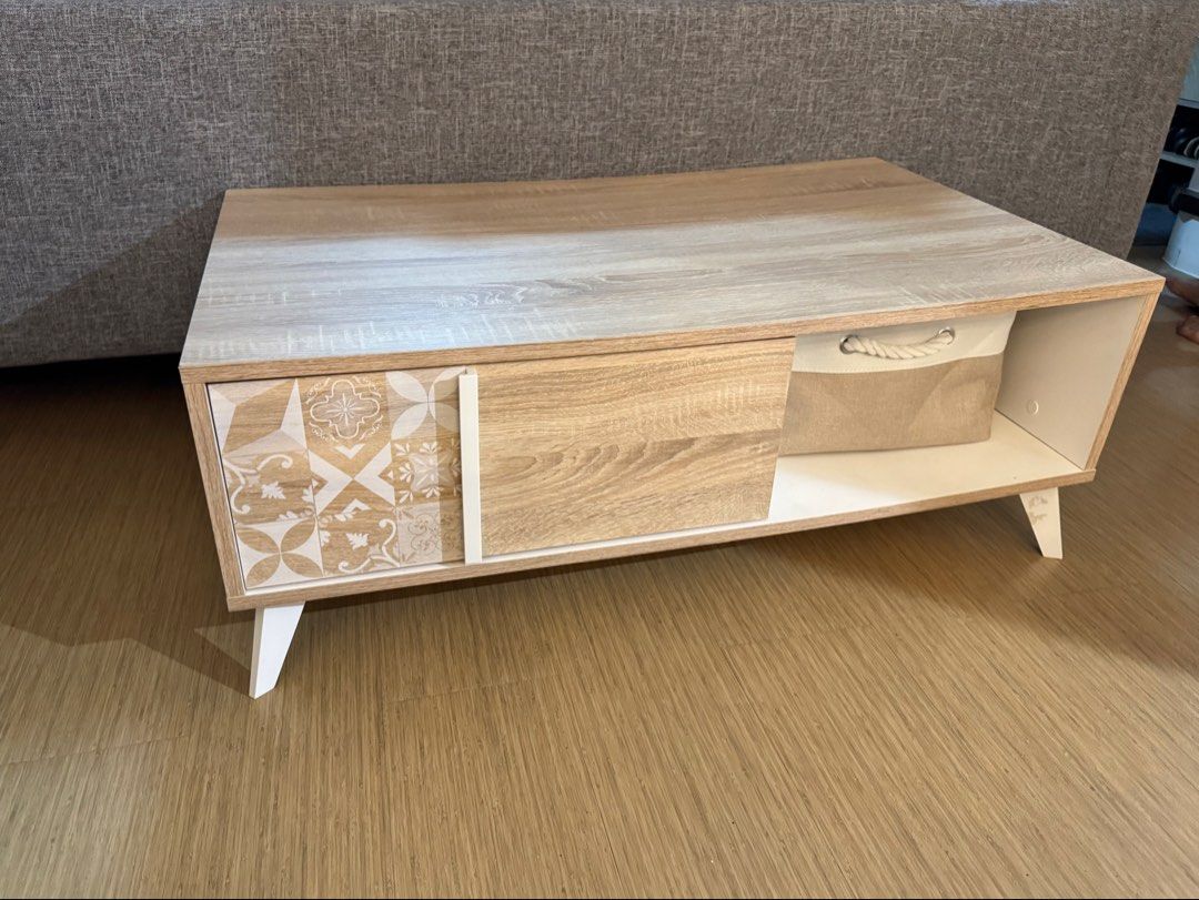 Blims Fine Furniture Center Table (Category: Tables & Sets) located in Calamba. Submitted by cheriiv (Listing ID 1467183249, Image 1). Description: - Modern wooden coffee table with stylish white slanted doors - Features 1 sliding wooden door and 1 patterned tile-design door section - Includes an open shelf - Beautiful light wood grain top surface.