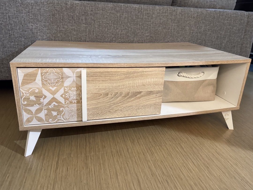 Blims Fine Furniture Center Table (Category: Tables & Sets) located in Calamba. Submitted by cheriiv (Listing ID 1467183249, Image 3). Description: - Modern wooden coffee table with stylish white slanted doors - Features 1 sliding wooden door and 1 patterned tile-design door section - Includes an open shelf - Beautiful light wood grain top surface.