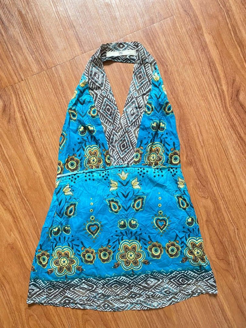 Blue Boho Floral Halter Mini Dress (Category: Dresses) located in Malasiqui. Submitted by finnley26 (Listing ID 1467240923, Image 2). Description: Bright blue halter dress with colorful floral patterns and brown geometric trim at the neck and hem. Lightweight fabric, sleeveless design with a plunging V-neckline. Great casual piece for warm weather or beach trips. Easy to slip on and style..