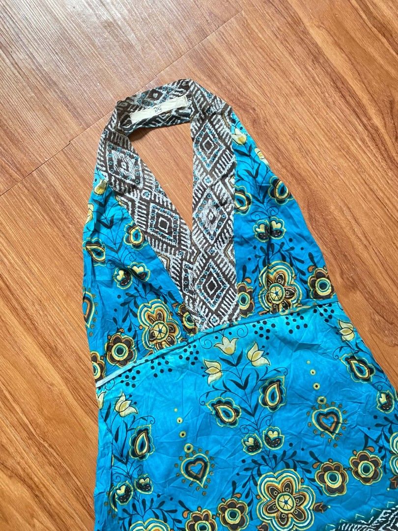 Blue Boho Floral Halter Mini Dress (Category: Dresses) located in Malasiqui. Submitted by finnley26 (Listing ID 1467240923, Image 3). Description: Bright blue halter dress with colorful floral patterns and brown geometric trim at the neck and hem. Lightweight fabric, sleeveless design with a plunging V-neckline. Great casual piece for warm weather or beach trips. Easy to slip on and style..