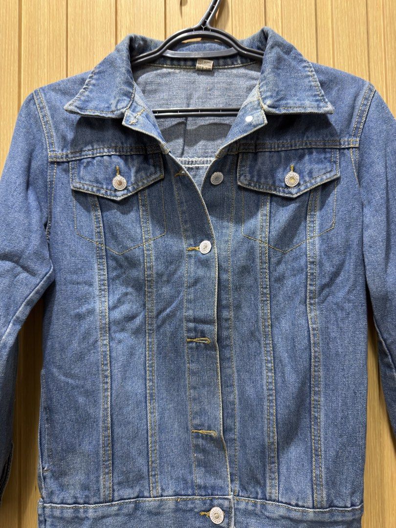 Blue Denim Jacket Size M (Category: Coats, Jackets and Outerwear) located in Bacoor. Submitted by preloved_with_love_ (Listing ID 1467334174, Image 2). Description: - Style: Classic blue denim jacket - Fit/Size: Medium (tag inside collar, exact measurements on label) - Details: Contrast stitching, metal button closures, two chest flap pockets - Material: Durable cotton denim - Versatility: Perfect for layering in any season.