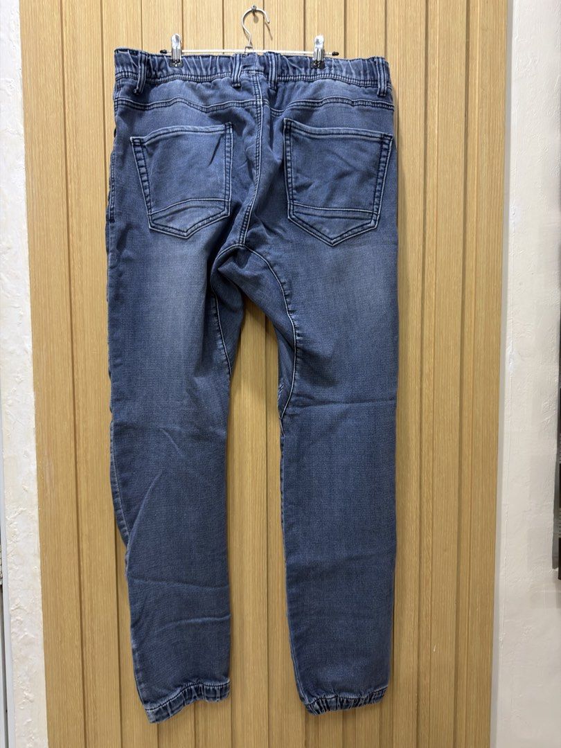 Blue Denim Jogger Jeans Drawstring Waist Size 33 (Category: Jeans) located in Bacoor. Submitted by preloved_with_love_ (Listing ID 1467254809, Image 2). Description: - Style: Casual blue denim jogger pants with a stylish worn-look wash - Size: Tag says size 33 - Waist: Comfortable elastic waistband with adjustable drawstring for easy pull-on wear - Pockets: Functional multiple pockets on the front and back - Details: Trendy cuffed hems at the ank