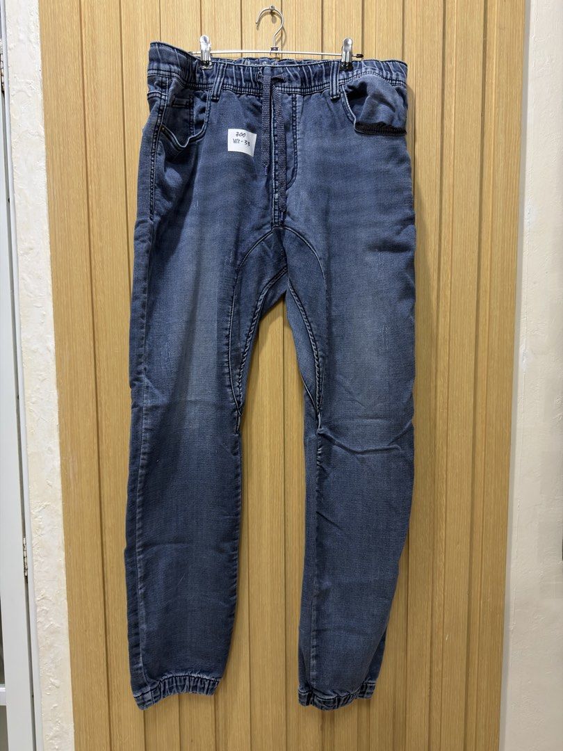 Blue Denim Jogger Jeans Drawstring Waist Size 33 (Category: Jeans) located in Bacoor. Submitted by preloved_with_love_ (Listing ID 1467254809, Image 3). Description: - Style: Casual blue denim jogger pants with a stylish worn-look wash - Size: Tag says size 33 - Waist: Comfortable elastic waistband with adjustable drawstring for easy pull-on wear - Pockets: Functional multiple pockets on the front and back - Details: Trendy cuffed hems at the ank