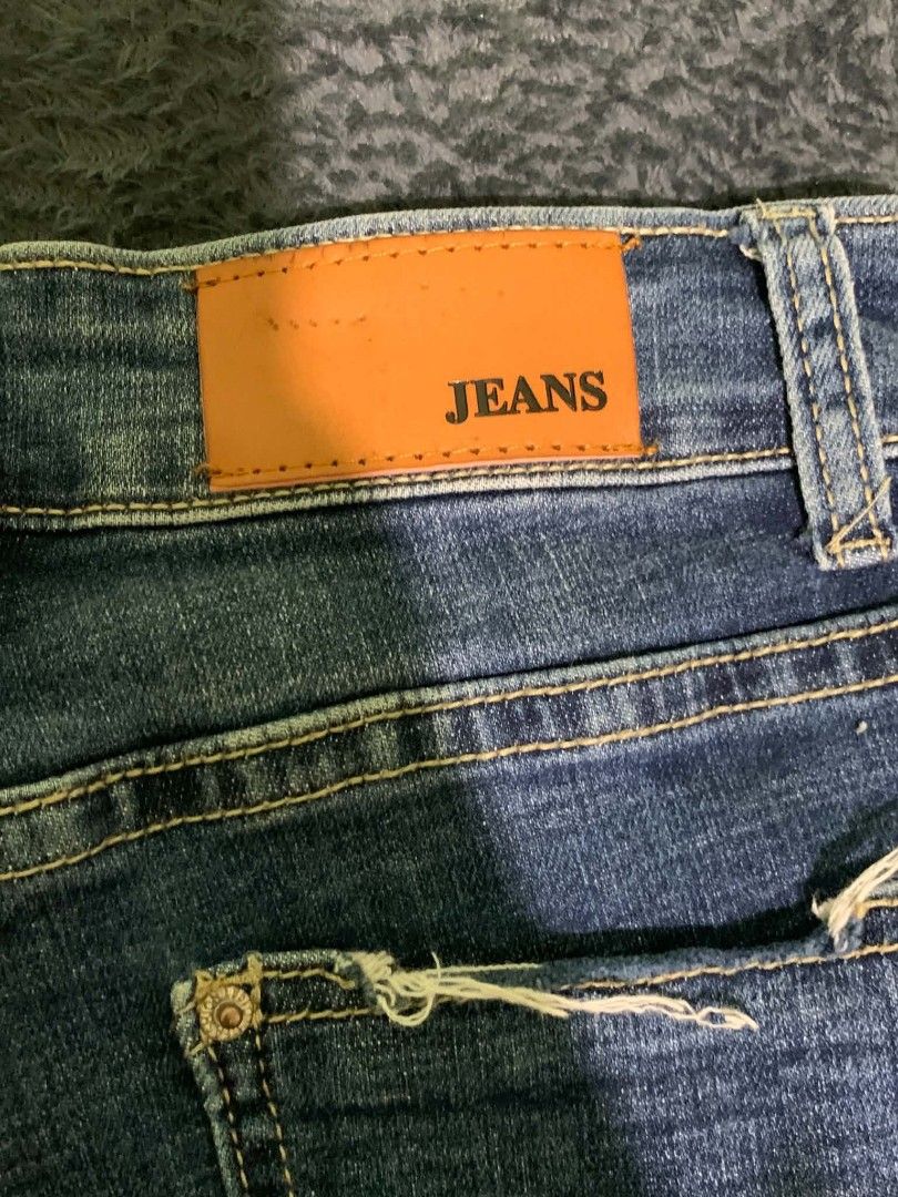 Blue Distressed Flare Jeans with Raw Hem (Category: Jeans) located in Manila. Submitted by quishi061210 (Listing ID 1467202928, Image 3). Description: - Style: Mid-rise flare jeans in a vintage medium wash - Details: Trendy distressed accents on the front and back pockets - Hem: Cool raw, frayed hem at the ankles - Design: Classic five-pocket layout with button and zip fly - Finishing touches: Contrast stitching and a brown leather back patch.
