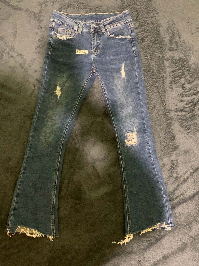 Blue Distressed Flare Jeans with Raw Hem (Category: Jeans) located in Manila. Submitted by quishi061210 (Listing ID 1467202928, Image 1). Description: - Style: Mid-rise flare jeans in a vintage medium wash - Details: Trendy distressed accents on the front and back pockets - Hem: Cool raw, frayed hem at the ankles - Design: Classic five-pocket layout with button and zip fly - Finishing touches: Contrast stitching and a brown leather back patch.
