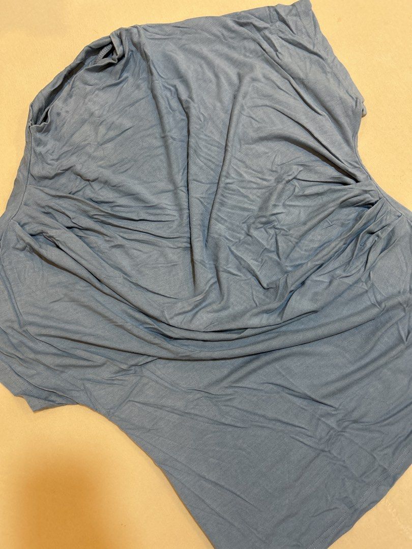 Blue draped asymmetrical sleeveless top (Category: Sleeveless) located in Quezon City. Submitted by kyokoaman (Listing ID 1467308205, Image 1). Description: - Color: Dusty blue - Material: Soft and stretchy lightweight jersey - Design: Draped cowl neckline with side gathering and asymmetrical hem - Styling: Perfect for layering or wearing solo with jeans and skirts.