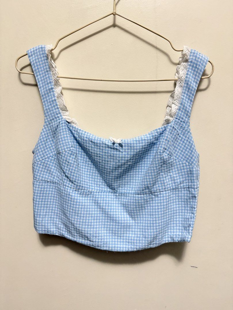 Blue Gingham Crop Top with Lace Straps (Category: Sleeveless) located in Quezon City. Submitted by j.steffy (Listing ID 1467327124, Image 1). Description: - Style: Blue and white gingham crop top - Neckline: Square neck with white eyelet lace trim - Details: Small white bow accent at the center front - Fit: Fully smocked elastic back panel for stretch and comfortable wear - Closure: Convenient side zipper on the left - Lining: Fully lined interio