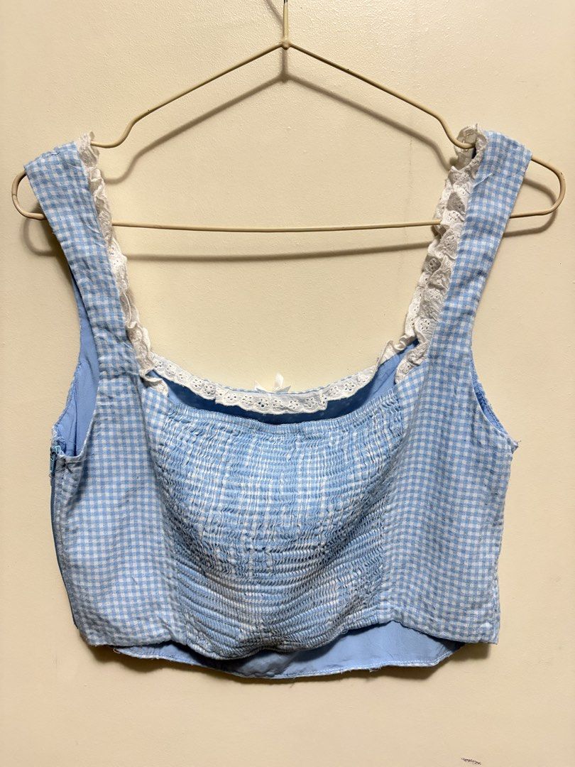 Blue Gingham Crop Top with Lace Straps (Category: Sleeveless) located in Quezon City. Submitted by j.steffy (Listing ID 1467327124, Image 2). Description: - Style: Blue and white gingham crop top - Neckline: Square neck with white eyelet lace trim - Details: Small white bow accent at the center front - Fit: Fully smocked elastic back panel for stretch and comfortable wear - Closure: Convenient side zipper on the left - Lining: Fully lined interio
