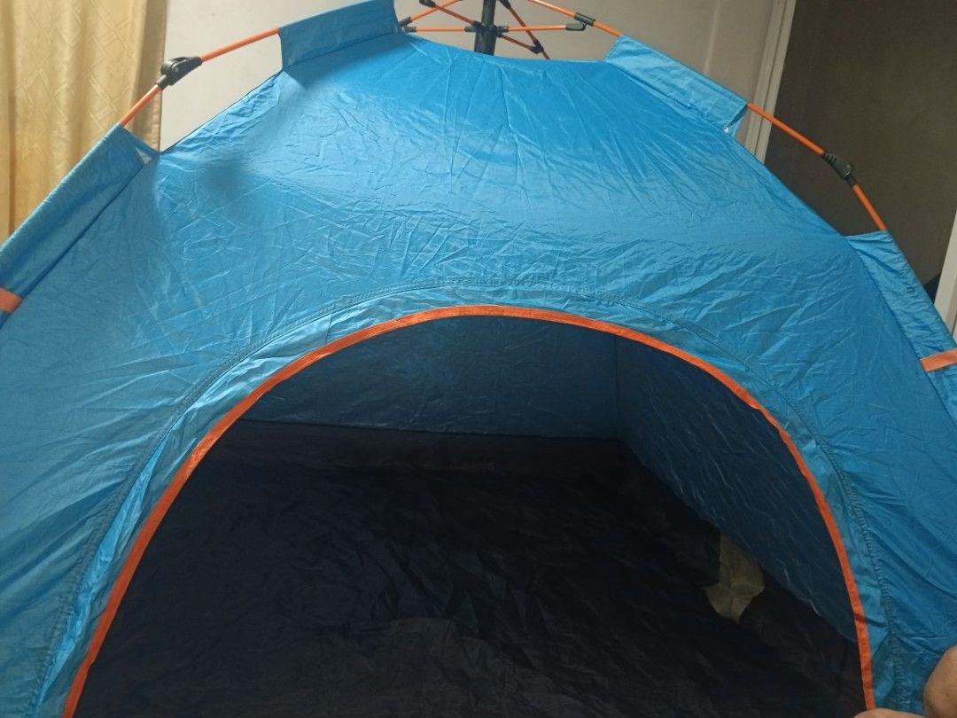 Blue waterproof pop-up camping tent with orange frame (Category: Hiking & Camping) located in Manila. Submitted by chay.perez1 (Listing ID 1467242680, Image 2). Description: - Quick and easy setup with integrated pole hub system and orange pop-up frame - Blue dome tent with dark interior floor lining to effectively block sunlight - Spacious interior featuring a top ridge ventilation flap - Lightweight material that packs down small - Perfect for 